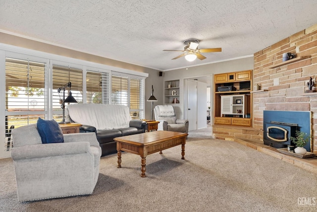 living room with built in shelves, a healthy amount of sunlight, a wood stove, and carpet floors