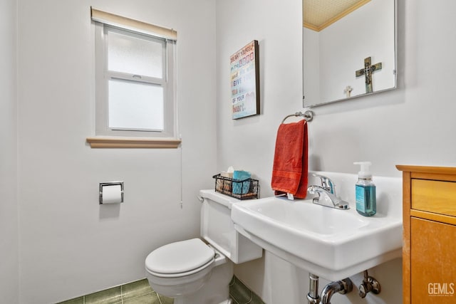 bathroom featuring tile patterned flooring, toilet, and sink