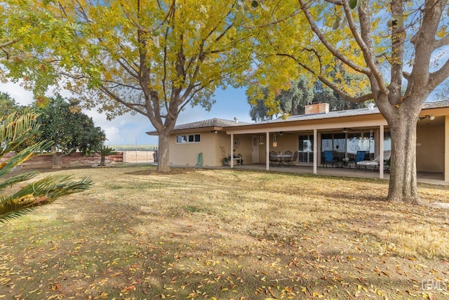 back of property with a patio area and ceiling fan