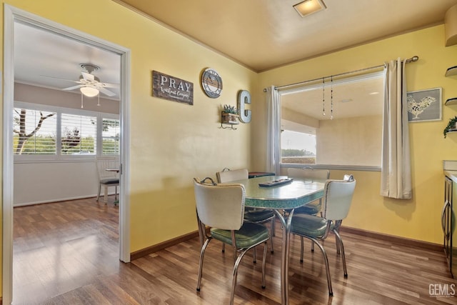 dining room featuring hardwood / wood-style floors, ceiling fan, and a healthy amount of sunlight