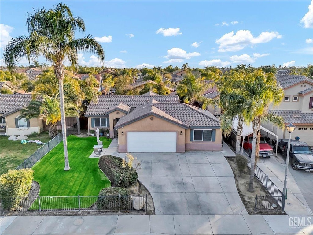 view of front of home with a garage and a front lawn