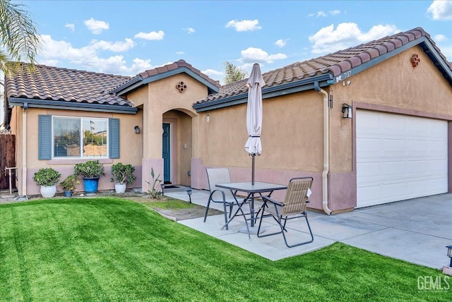 rear view of property featuring a garage and a yard