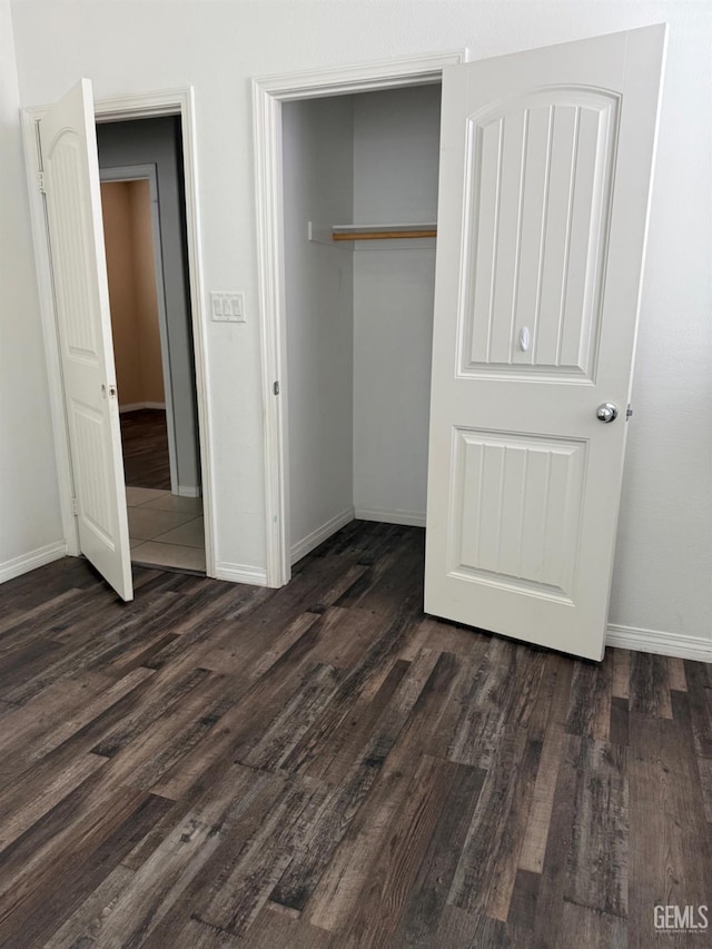 6511 Epley Ct, Bakersfield, CA 93313 - unfurnished bedroom featuring dark wood-type flooring, a closet, and baseboards