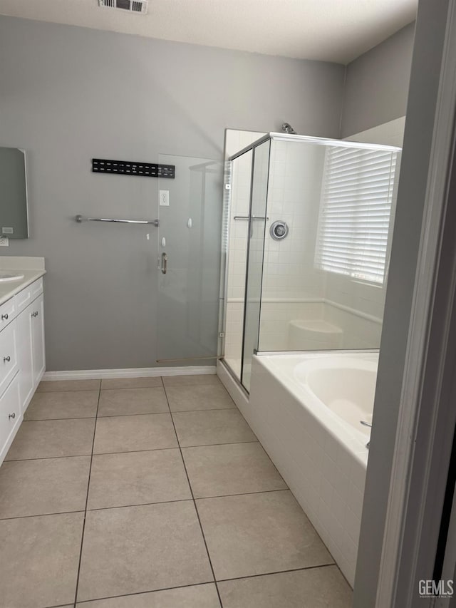 6511 Epley Ct, Bakersfield, CA 93313 - bathroom featuring vanity, a bath, a stall shower, tile patterned flooring, and baseboards