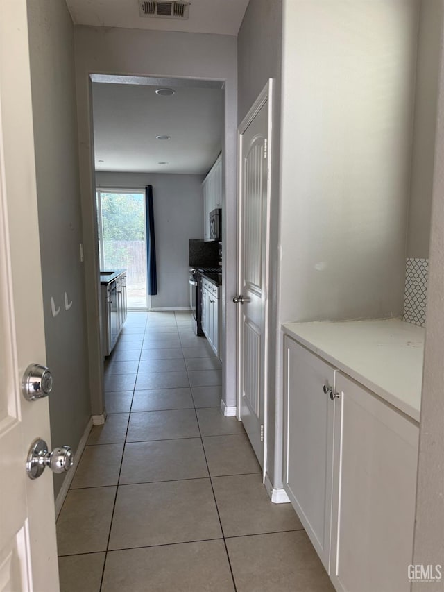 6511 Epley Ct, Bakersfield, CA 93313 - corridor featuring light tile patterned floors and baseboards