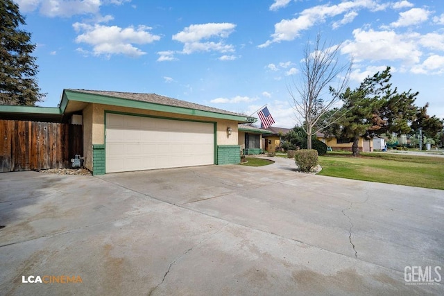 ranch-style house with a garage and a front lawn