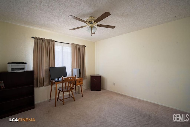 office area with a textured ceiling, ceiling fan, and carpet