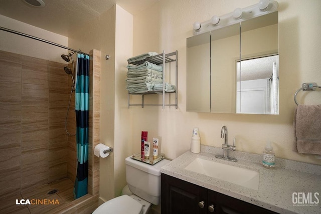 bathroom with vanity, curtained shower, and toilet