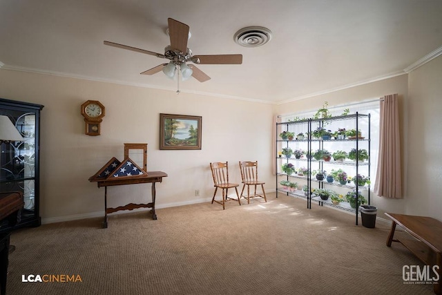 living area with ceiling fan, ornamental molding, and carpet floors