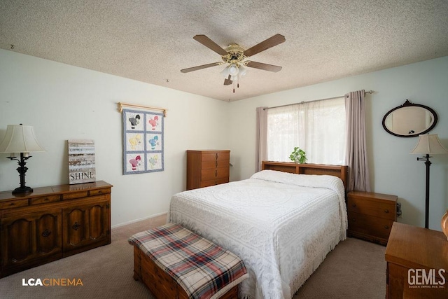 bedroom with ceiling fan, light colored carpet, and a textured ceiling