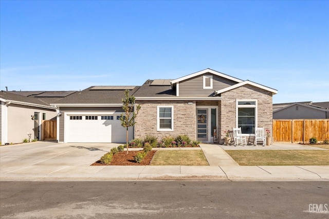 view of front facade featuring solar panels and a garage