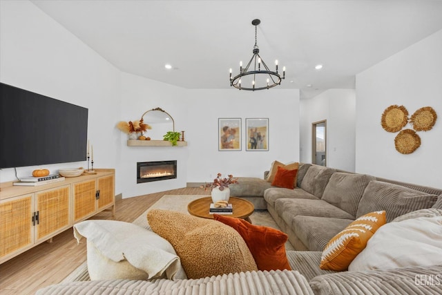 living room featuring light hardwood / wood-style flooring and a notable chandelier