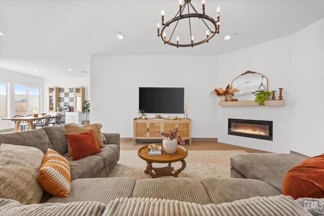 living room with a chandelier and light hardwood / wood-style floors