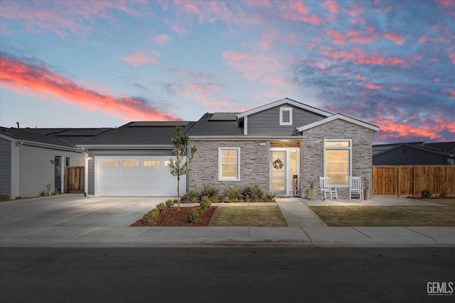 view of front of house with solar panels and a garage