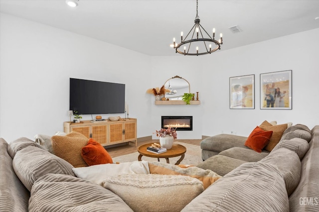 living room featuring hardwood / wood-style flooring and an inviting chandelier