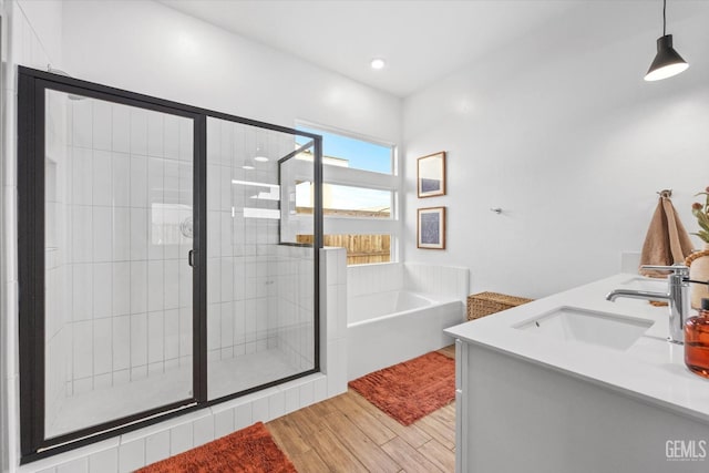 bathroom featuring vanity and independent shower and bath