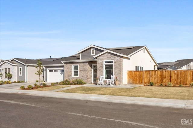 view of front of house featuring a garage and a front lawn