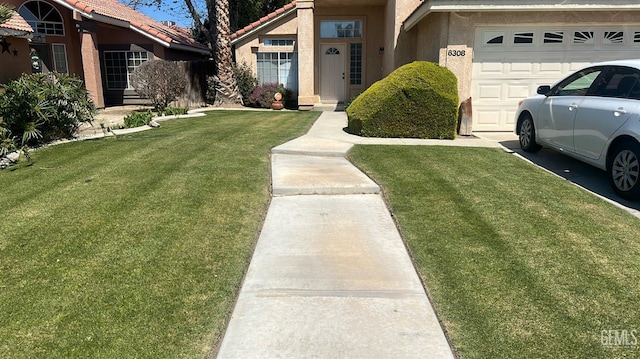 6308 Ambergrove St, Bakersfield, CA 93313 - view of front of home with an attached garage, a front yard, stucco siding, and a tile roof