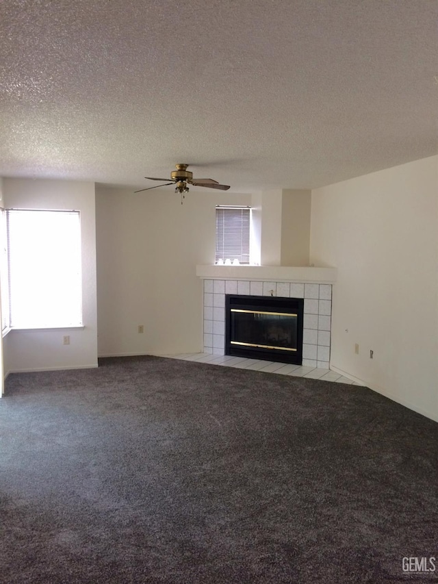 6308 Ambergrove St, Bakersfield, CA 93313 - unfurnished living room featuring a tiled fireplace, carpet flooring, a ceiling fan, and a textured ceiling