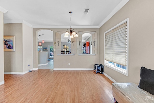 5510 Edge Water Ct, Bakersfield, CA 93312 - dining area with a chandelier, light wood-style flooring, arched walkways, ornamental molding, and healthy amount of natural light