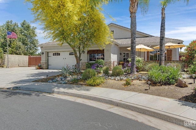 5510 Edge Water Ct, Bakersfield, CA 93312 - view of front facade with an attached garage, stucco siding, driveway, and a tiled roof
