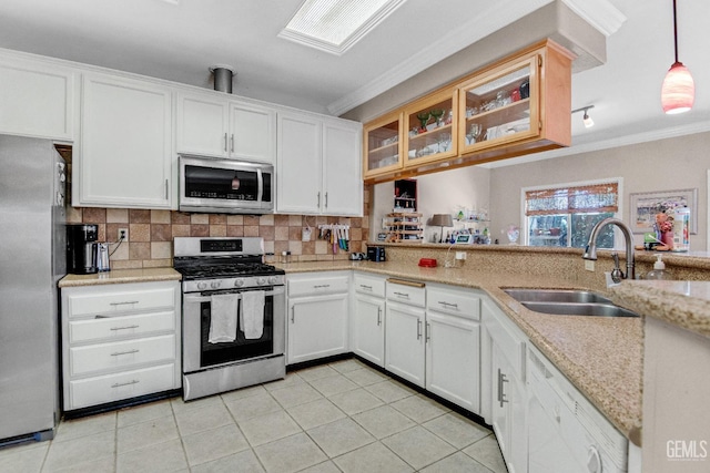 5510 Edge Water Ct, Bakersfield, CA 93312 - kitchen featuring appliances with stainless steel finishes, tasteful backsplash, crown molding, light tile patterned floors, and white cabinets