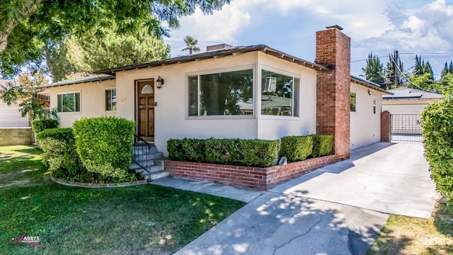 1825 Camino Primavera, Bakersfield, CA 93306 - view of front facade with a chimney, stucco siding, and a front lawn