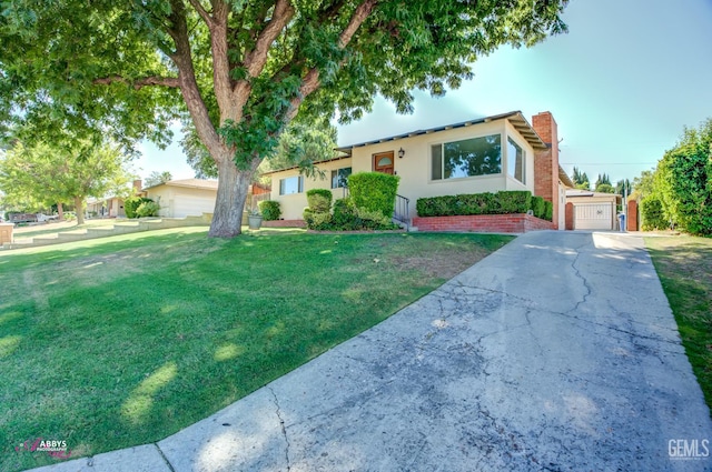 1825 Camino Primavera, Bakersfield, CA 93306 - ranch-style home featuring a front lawn, concrete driveway, a garage, stucco siding, and a chimney