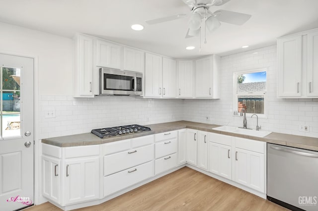1825 Camino Primavera, Bakersfield, CA 93306 - kitchen featuring stainless steel appliances, white cabinetry, tasteful backsplash, a ceiling fan, and recessed lighting