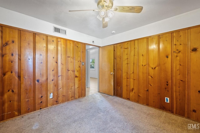 1805 Morgan Ln, Bakersfield, CA 93306 - unfurnished bedroom with carpet, wood walls, and ceiling fan