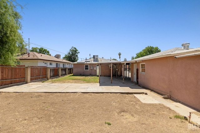 1805 Morgan Ln, Bakersfield, CA 93306 - rear view of property featuring a fenced backyard, a patio area, and stucco siding