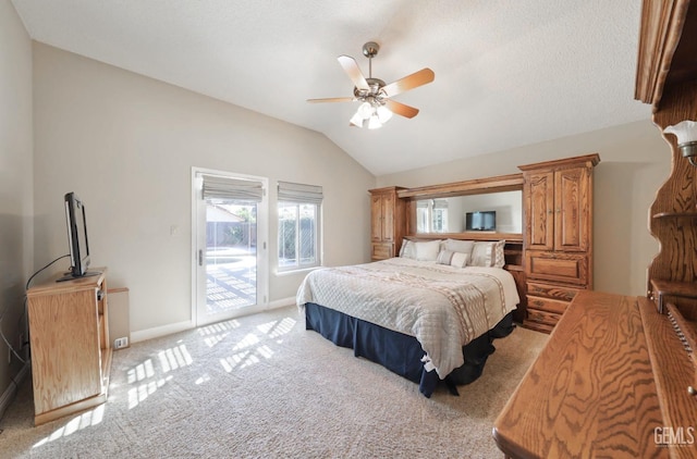 bedroom with a ceiling fan, baseboards, lofted ceiling, access to exterior, and light colored carpet