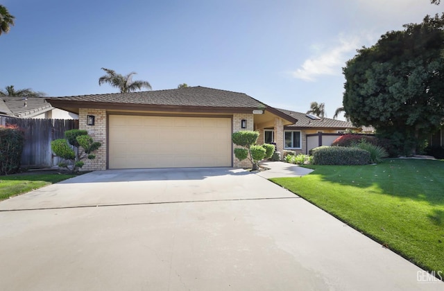 view of front of property with driveway, an attached garage, fence, a front lawn, and brick siding