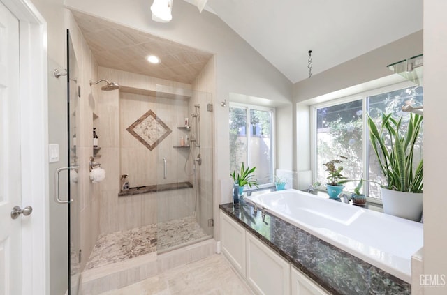 full bath featuring a shower stall, a bath, and lofted ceiling