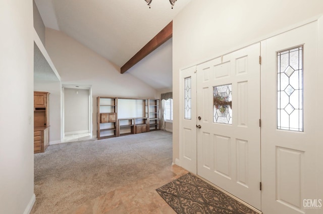 entrance foyer featuring beam ceiling, light colored carpet, baseboards, and high vaulted ceiling