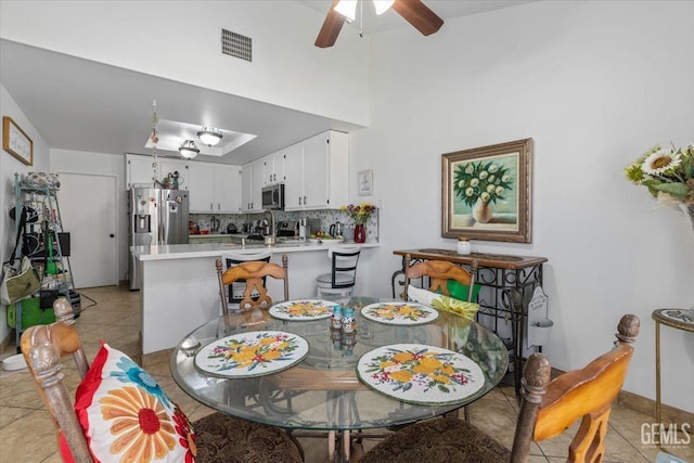 dining space featuring a ceiling fan, visible vents, and light tile patterned floors