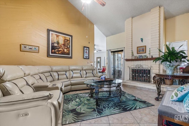 tiled living room with a textured ceiling, a fireplace, high vaulted ceiling, and a ceiling fan