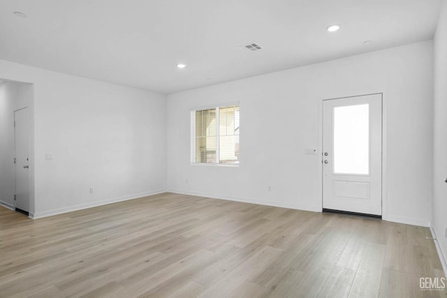 interior space with light wood-type flooring, visible vents, baseboards, and recessed lighting