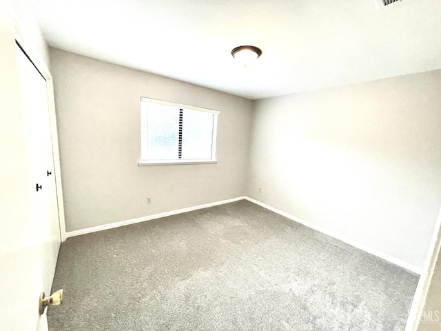 unfurnished bedroom featuring a closet, baseboards, and carpet