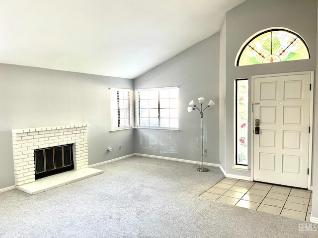 carpeted foyer entrance with baseboards, high vaulted ceiling, tile patterned flooring, and a brick fireplace