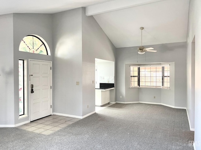 carpeted foyer entrance with baseboards, ceiling fan, high vaulted ceiling, and beamed ceiling