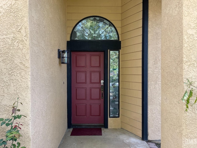 property entrance with stucco siding