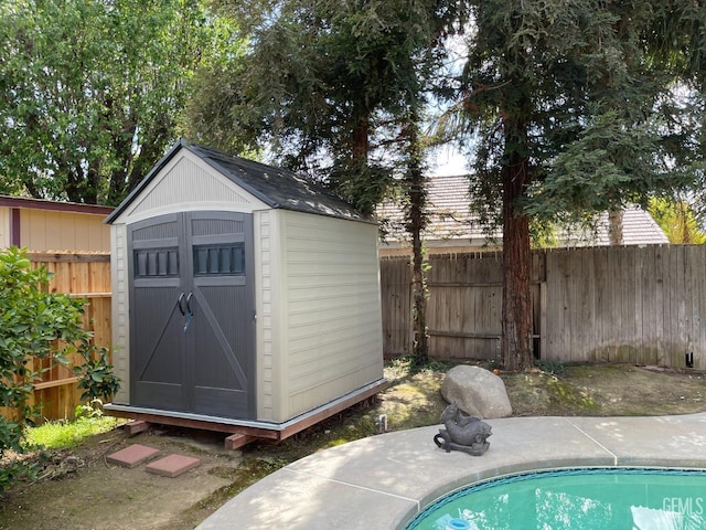 view of shed featuring a fenced backyard and a fenced in pool