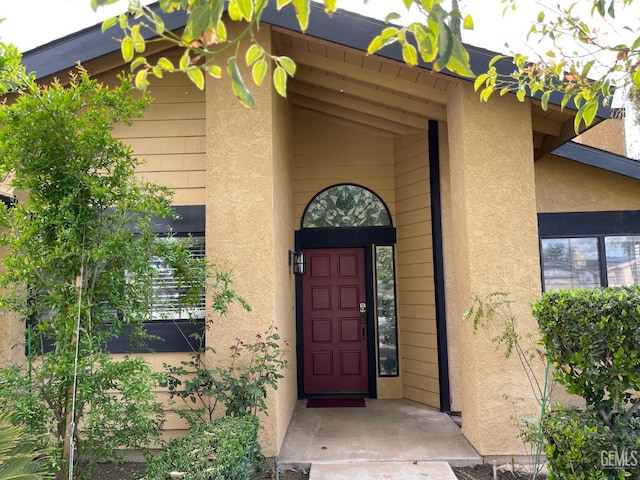 view of exterior entry with stucco siding