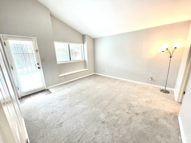 interior space featuring baseboards and lofted ceiling
