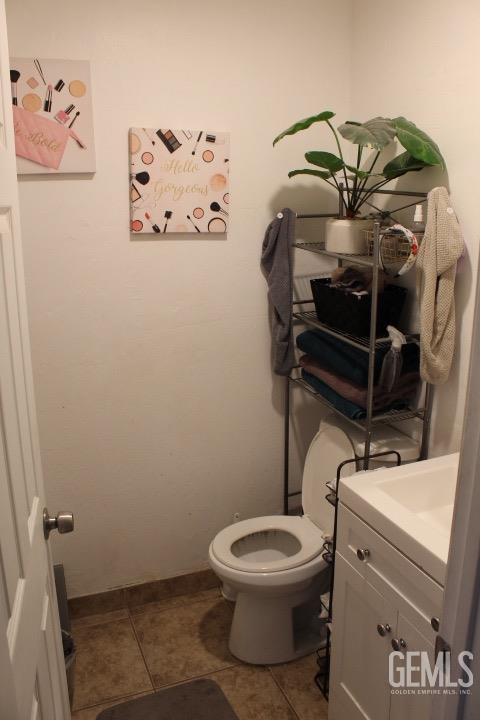 bathroom with tile patterned floors, vanity, and toilet