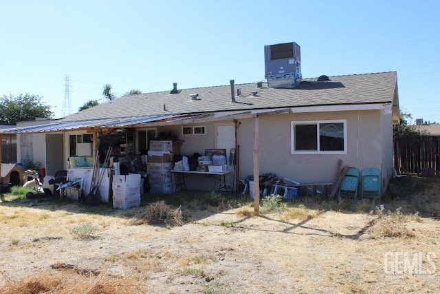 rear view of house featuring central AC