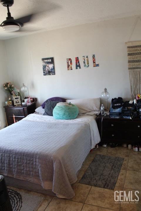 bedroom featuring ceiling fan and tile patterned flooring