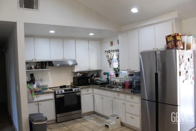 kitchen featuring appliances with stainless steel finishes, vaulted ceiling, sink, stone counters, and white cabinetry