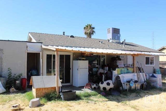 back of house with central AC unit